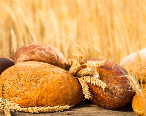 Photo: Homemade bread and wheat on the wooden table Homemade bread and wheat on the wooden table