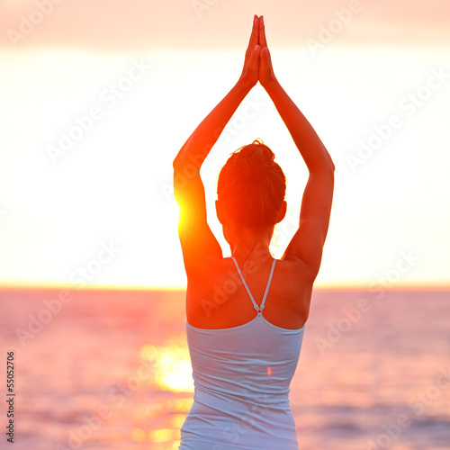 Photo: Meditation Yoga woman meditating at beach sunset Meditation Yoga woman meditating at beach sunset