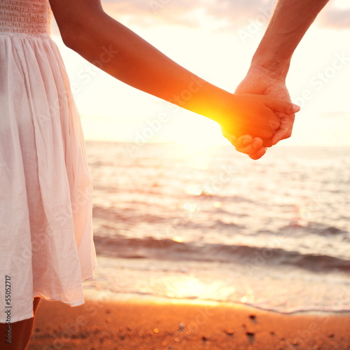 Photo: Love - romantic couple holding hands, beach sunset Love - romantic couple holding hands, beach sunset