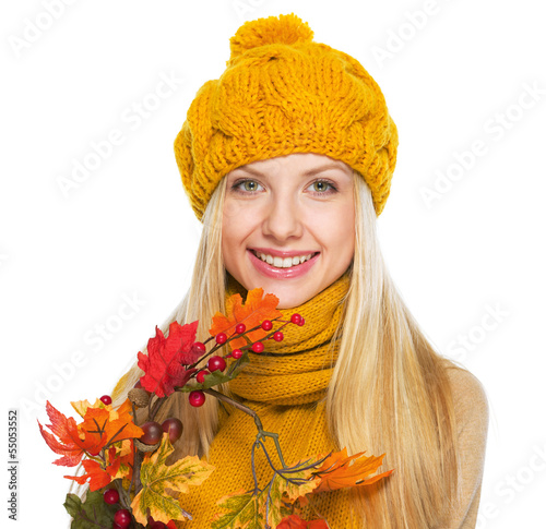 Photo: Smiling young woman holding autumn bouquet Smiling young woman holding autumn bouquet