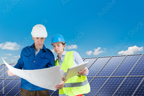 Photo: engineers installing solar panels engineers installing solar panels
