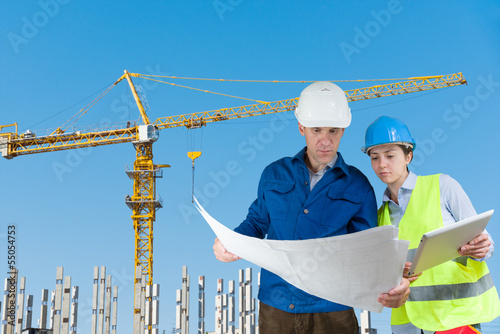 Photo: Foreman and engineer with blueprints Foreman and engineer with blueprints