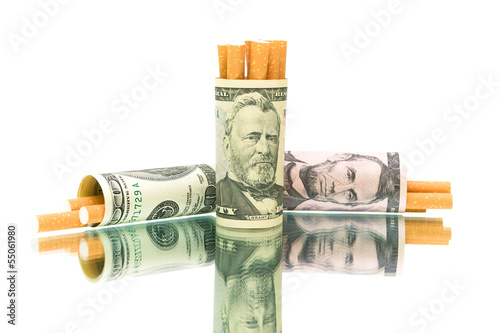 Photo: cigarettes and money. white background - horizontal photo. cigarettes and money. white background - horizontal photo.