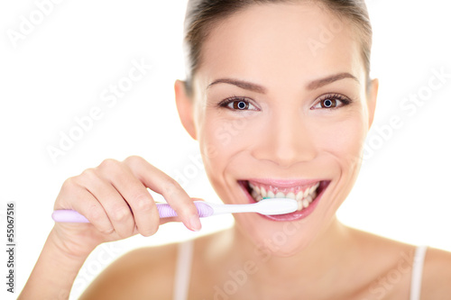 Photo: Woman brushing teeth holding toothbrush Woman brushing teeth holding toothbrush