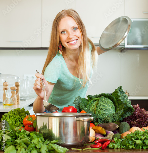 Photo: Long-haired woman cooking with ladle Long-haired woman cooking with ladle