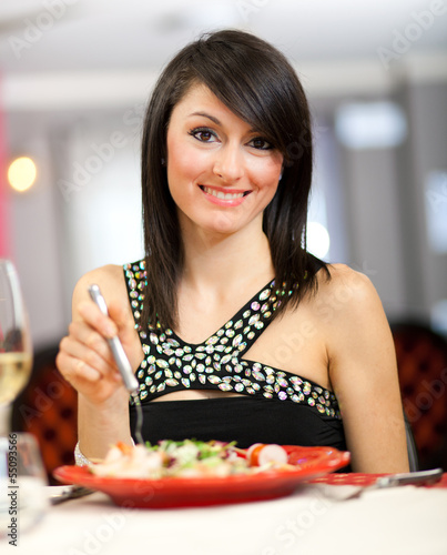 Photo: Beautiful woman eating at the restaurant Beautiful woman eating at the restaurant