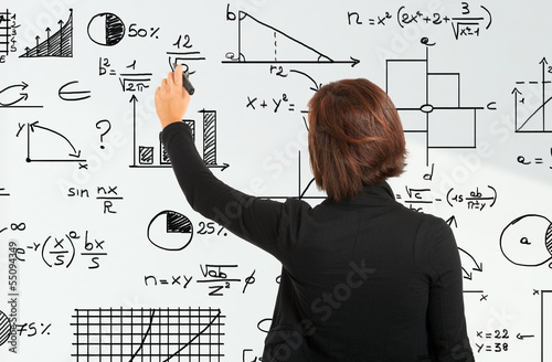 Photo: Woman writing formulas Woman writing formulas