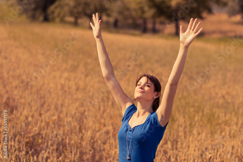 Photo: Beautiful young woman with enjoying the sun in nature Beautiful young woman with enjoying the sun in nature