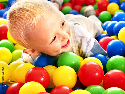 Photo: Child in colored ball. Child in colored ball.