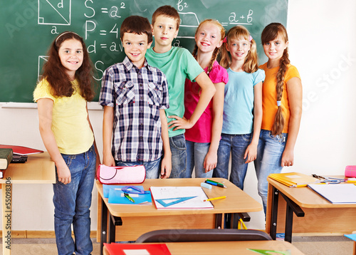 Photo: School child sitting in classroom. School child sitting in classroom.
