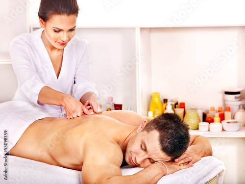 Photo: Man getting massage in spa. Man getting massage in spa.