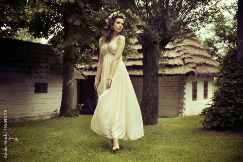 Photo: Lady in white dress dancing on the grass Lady in white dress dancing on the grass