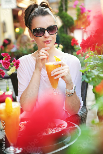Photo: Thirsty lady drinking an orange juice Thirsty lady drinking an orange juice