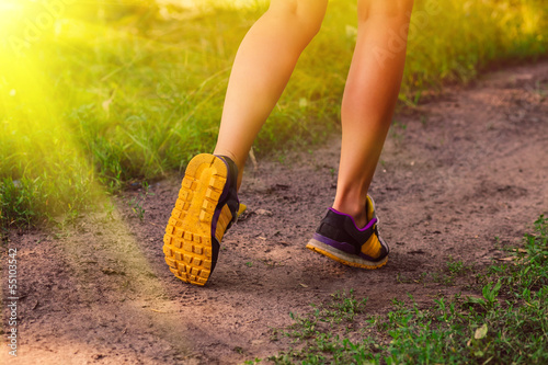 Photo: sunlight sports a shoes female large legs running, exercising an sunlight sports a shoes female large legs running, exercising an