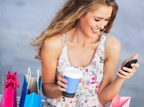Photo: Woman having a break from shopping Woman having a break from shopping