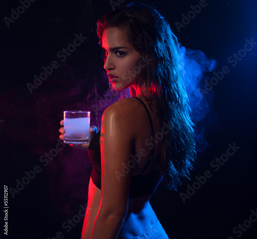 Photo: Young hot woman posing and holding a glass of alcohol drink Young hot woman posing and holding a glass of alcohol drink
