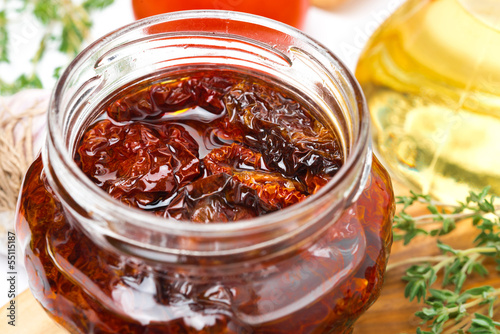 Photo: sun dried tomatoes in a glass jar close-up sun dried tomatoes in a glass jar close-up