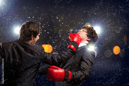 Photo: Two young businessman boxing Two young businessman boxing