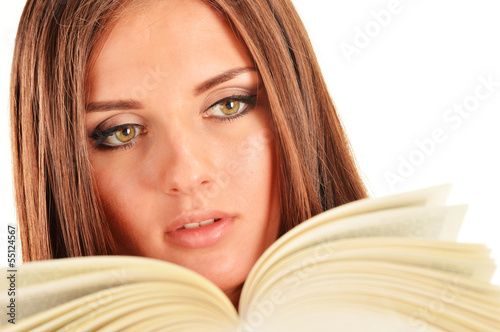 Photo: Young woman reading a book. Female student learning Young woman reading a book. Female student learning