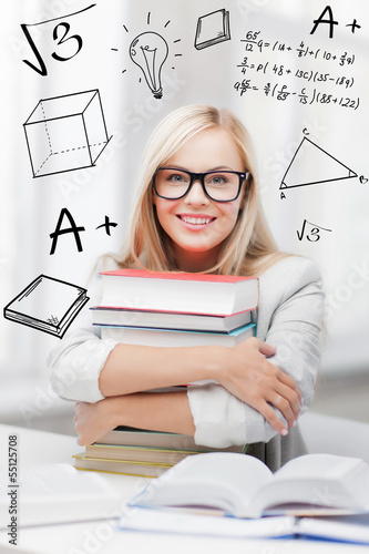 Photo: student with stack of books and doodles student with stack of books and doodles