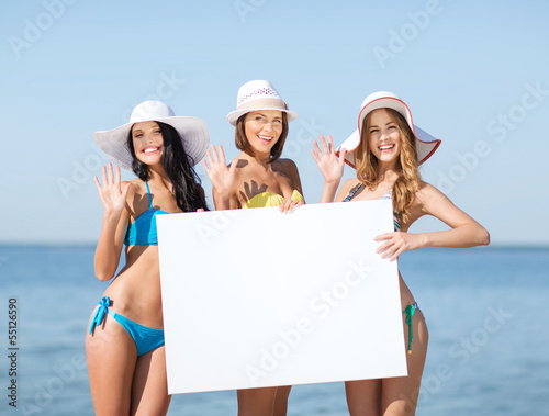 Photo: girls with blank board on the beach girls with blank board on the beach