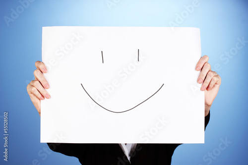 Photo: Woman holding paper with smile, on color background Woman holding paper with smile, on color background