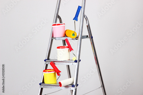Photo: Metal ladder and paint in room Metal ladder and paint in room