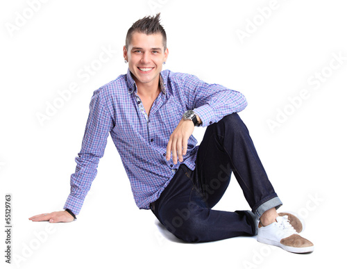 Photo: Flirtatious man sitting on the floor Flirtatious man sitting on the floor