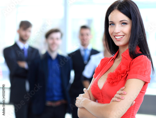 Photo: Face of beautiful woman on the background of business people Face of beautiful woman on the background of business people