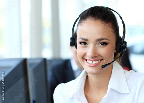 Photo: Female customer support operator with headset and smiling Female customer support operator with headset and smiling