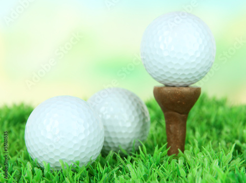 Photo: Golf ball on green grass outdoor close up Golf ball on green grass outdoor close up