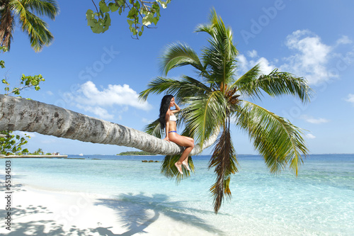 Photo: Woman on palm on sea backgroud Woman on palm on sea backgroud