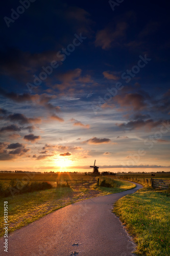 Photo: warm summer sunrise and windmill warm summer sunrise and windmill