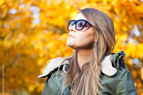 Photo: Woman relaxing outdoor during autumn Woman relaxing outdoor during autumn