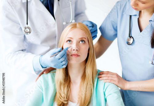 Photo: plastic surgeon and nurse with patient plastic surgeon and nurse with patient