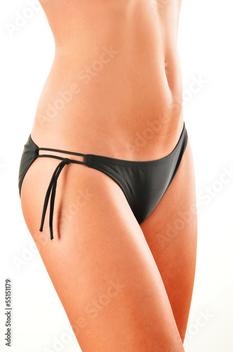 Photo: Slim woman's body isolated on white background Slim woman's body isolated on white background