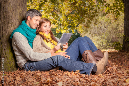 Photo: autumn couple with tablet online autumn couple with tablet online