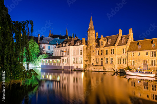 Photo: Bruges canal at night and medieval houses with reflection in wat Bruges canal at night and medieval houses with reflection in wat