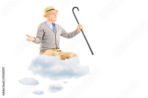 Photo: Happy senior man floating on a cloud and spreading arms Happy senior man floating on a cloud and spreading arms