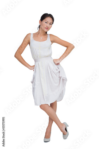 Photo: Serious brunette posing with hands on hips Serious brunette posing with hands on hips
