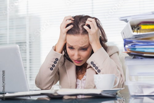 Photo: Nervous businesswoman pulling her hair out Nervous businesswoman pulling her hair out