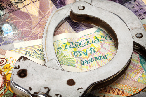 Photo: handcuffs and money handcuffs and money