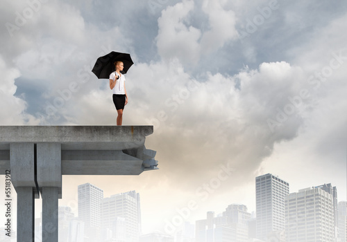 Photo: Businesswoman standing on bridge Businesswoman standing on bridge