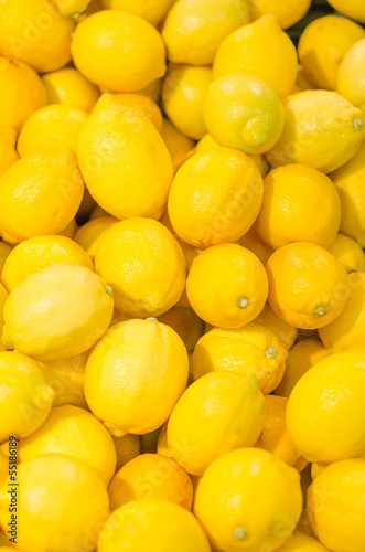 Photo: Lot of bright yellow lemons in supermarket Lot of bright yellow lemons in supermarket