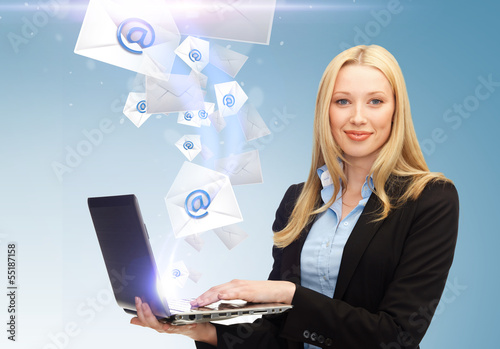 Photo: businesswoman holding laptop with email sign businesswoman holding laptop with email sign