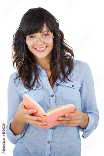Photo: Young woman wearing glasses and holding book Young woman wearing glasses and holding book