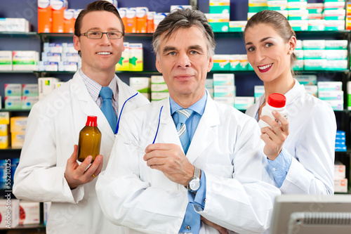 Photo: Team of pharmacists in pharmacy Team of pharmacists in pharmacy