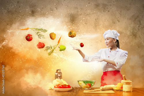 Photo: Asian female cooking with magic Asian female cooking with magic