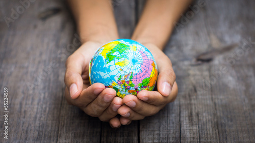 Photo: Person holding a globe Person holding a globe