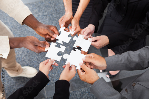 Photo: Businesspeople Holding Jigsaw Puzzle Businesspeople Holding Jigsaw Puzzle